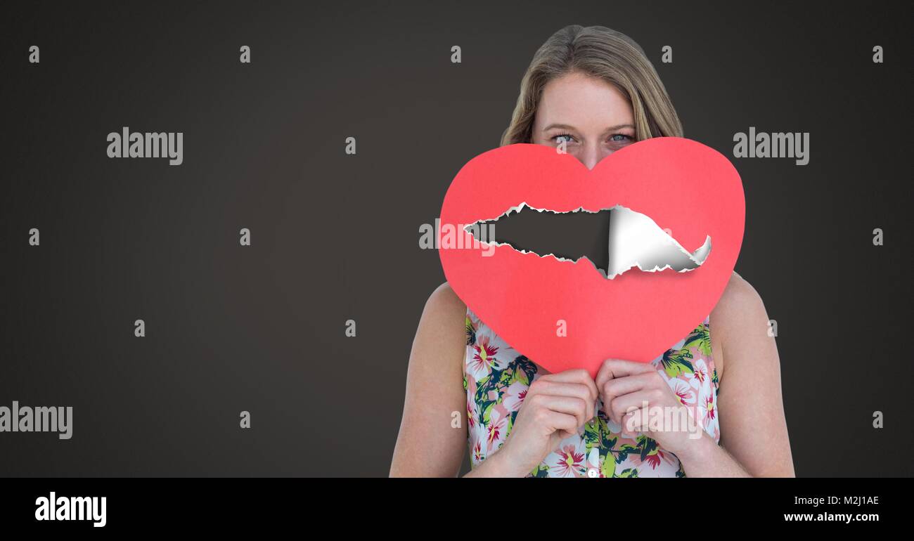 Woman holding hurt love heart with torn paper Stock Photo