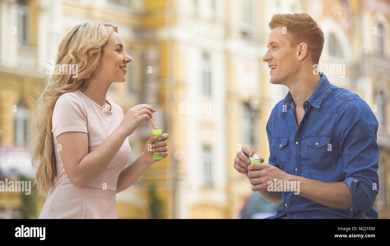 Girlfriend and boyfriend looking at each other with love, making soap  bubbles, stock video Stock Photo - Alamy