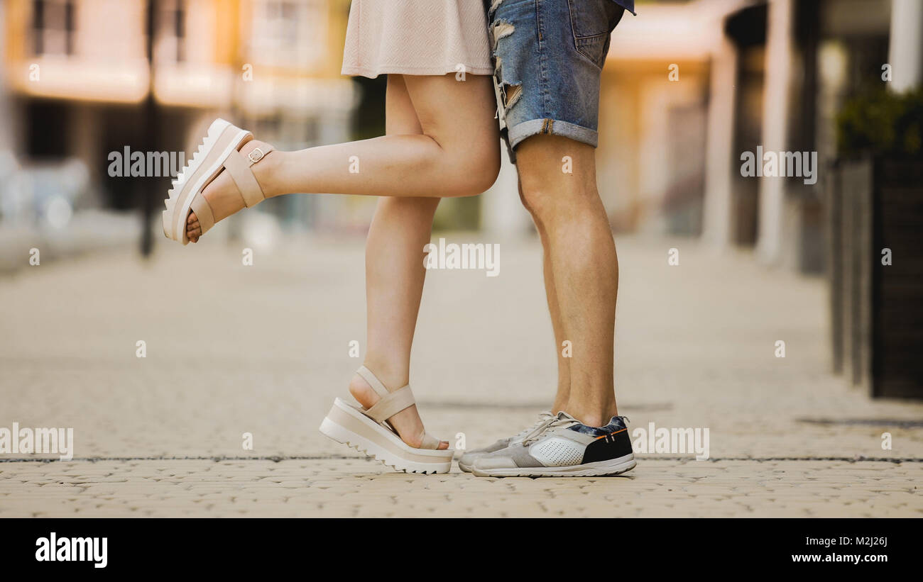 Legs of flirty girlfriend and boyfriend in love hugging and kissing in ...
