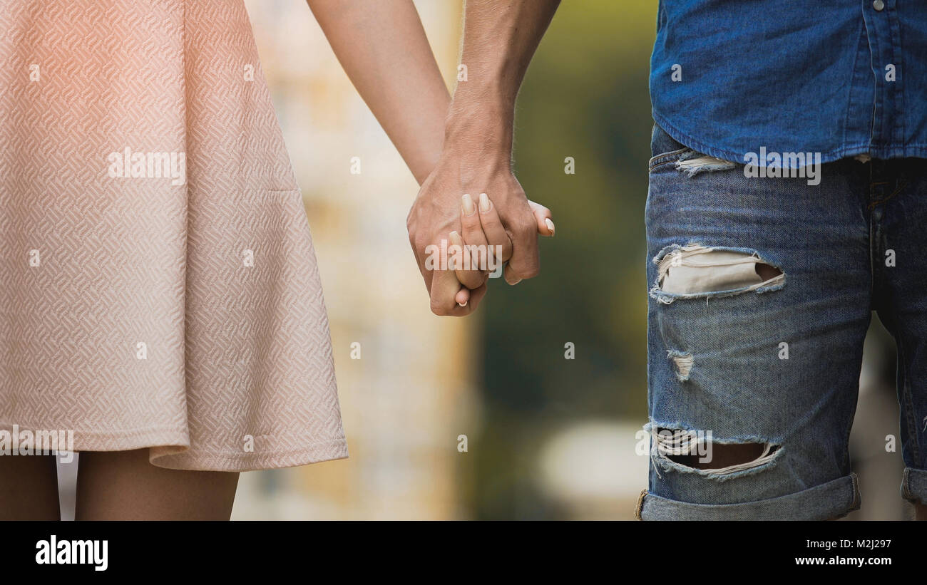 Young woman and man holding hands, tender relationship of sweet couple ...