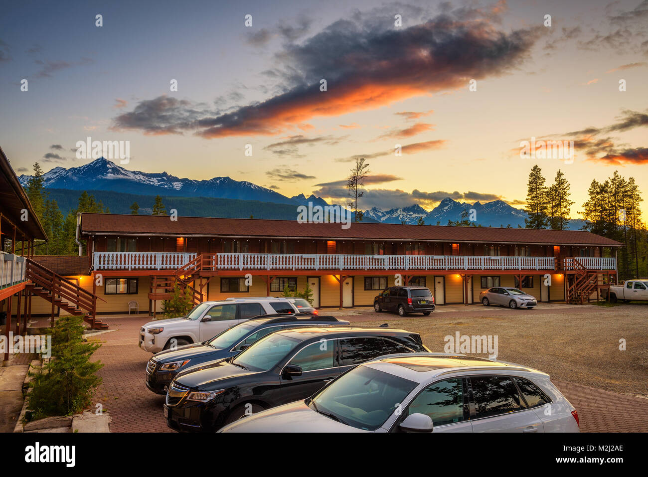Sunset above Rocky Mountains and the Rocky Inn in Valemount, Canada Stock Photo