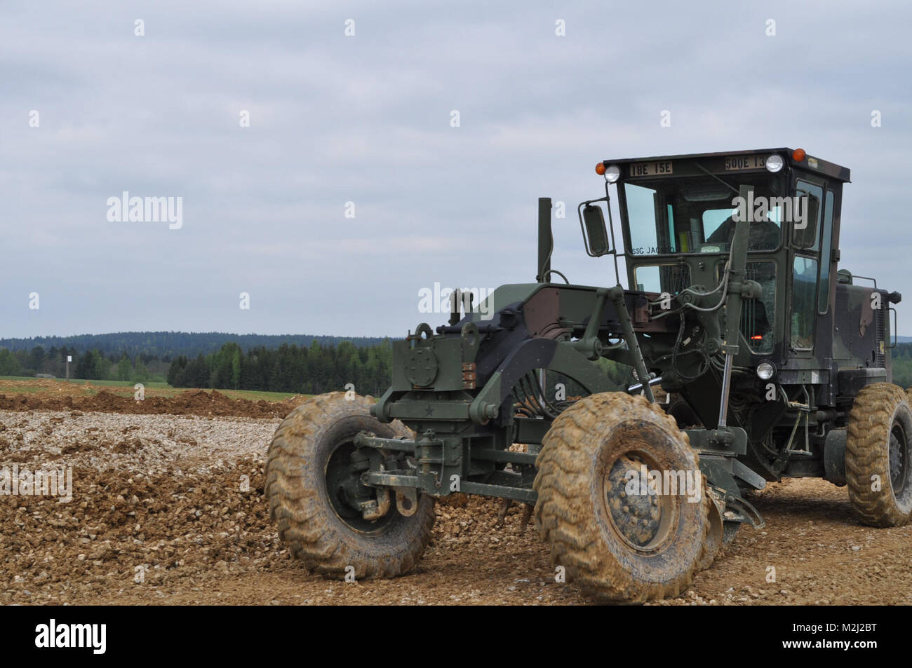 Army construction soldier flattens area by Stock Photo Alamy