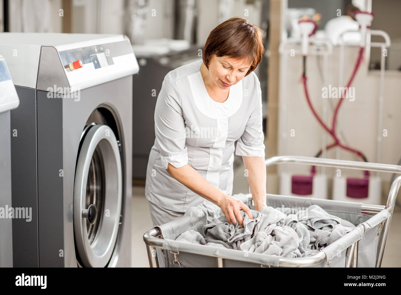 Senior washwoman in the laundry Stock Photo Alamy