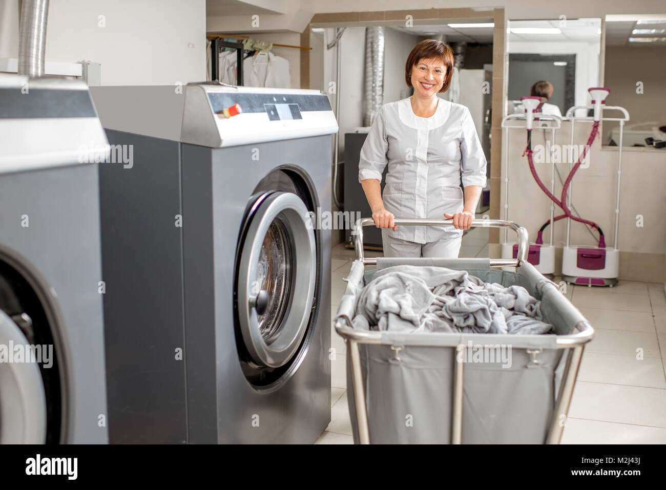 Senior washwoman in the laundry Stock Photo Alamy