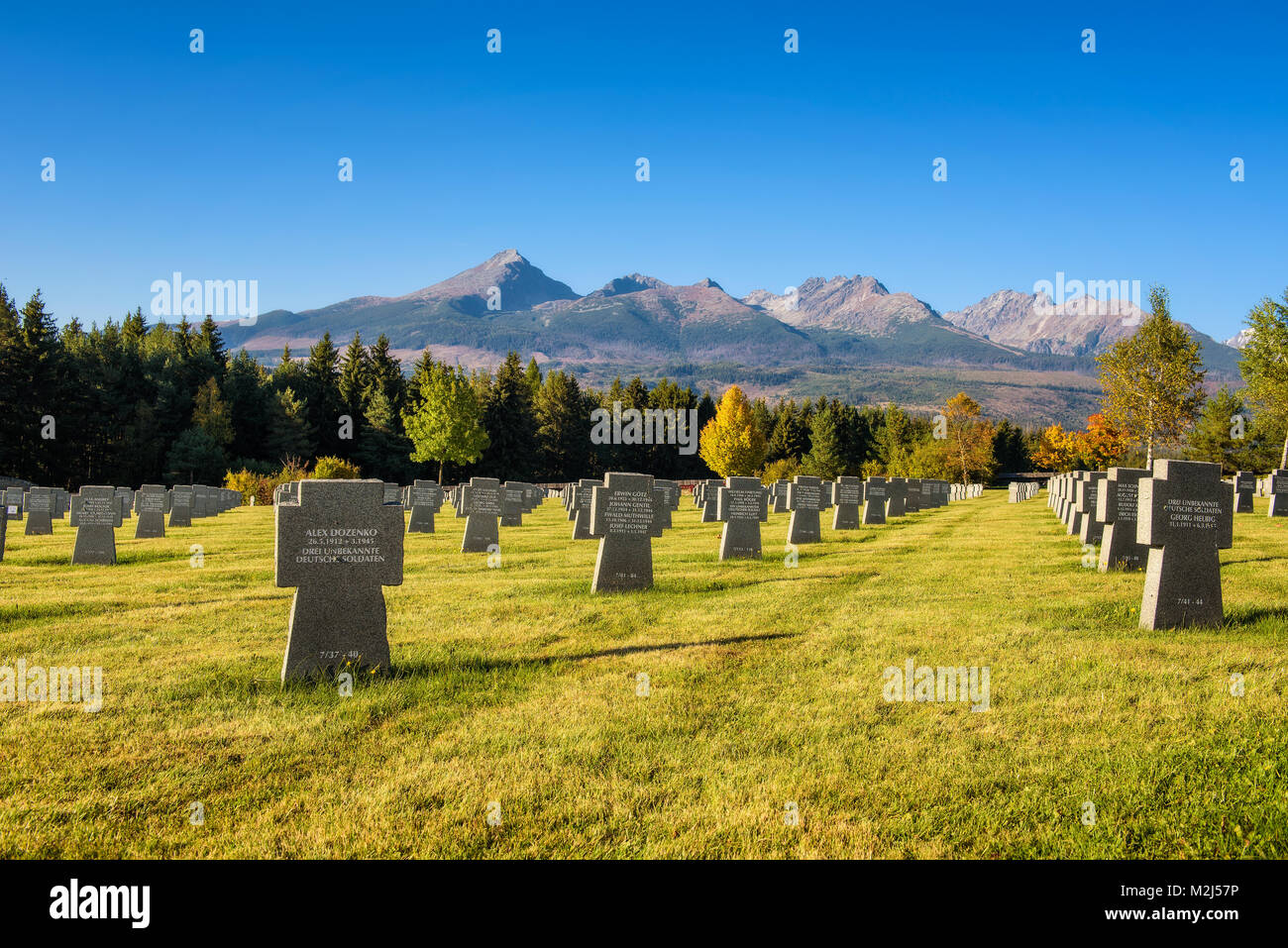 German military cemetery in autumn with High Tatras mountains in the background Stock Photo