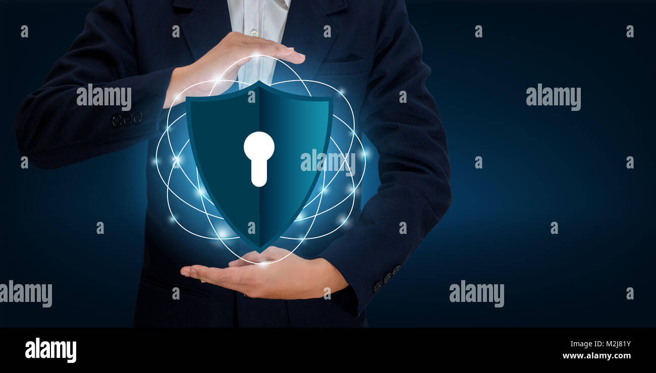 Businessmen shake hands to protect information in cyberspace. Businessman holding shield protect icon protection network security computer and safe yo Stock Photo