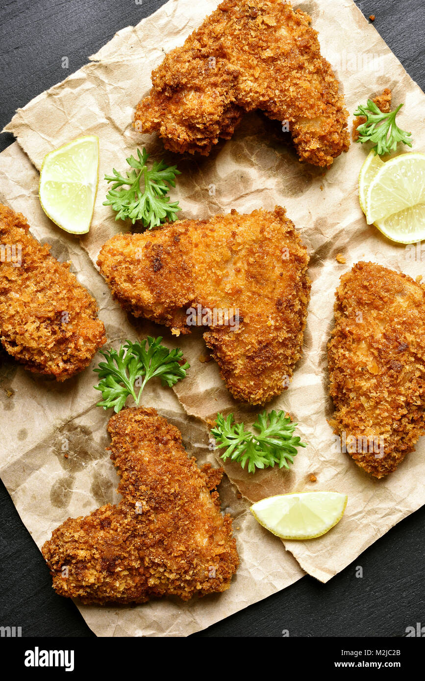 Homemade crispy breaded chicken wings on paper. Top view, flat lay Stock Photo Alamy