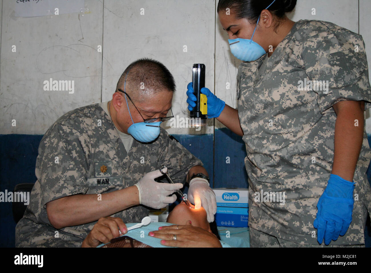 Army Reserve dentist, Maj. George Wan from Los Angeles, prepares a ...