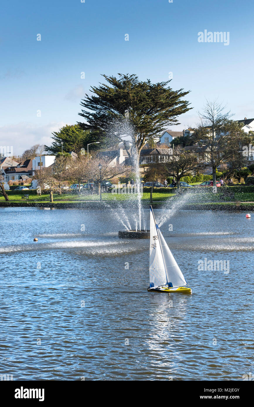 A model sailboat on Trenance Boating Lake in Newquay Cornwall. Stock Photo