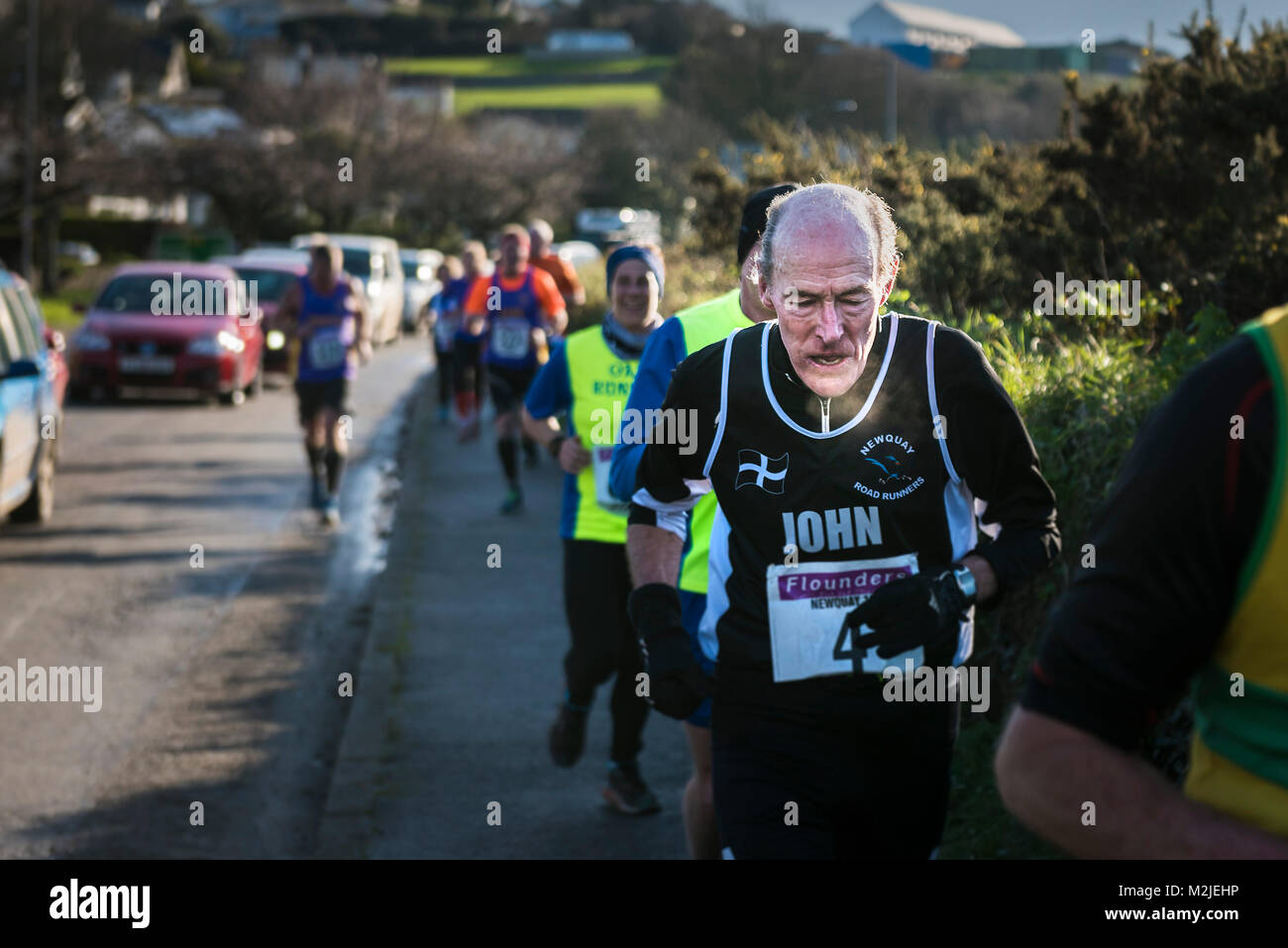 Mature runners competing in a road race in Newquay Cornwall. Stock Photo