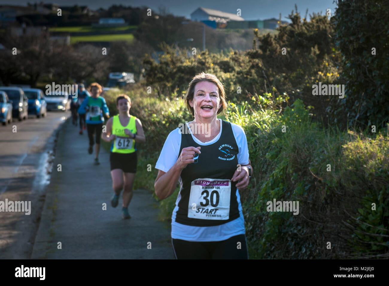 Mature female runners competing in a road race in Newquay Cornwall. Stock Photo