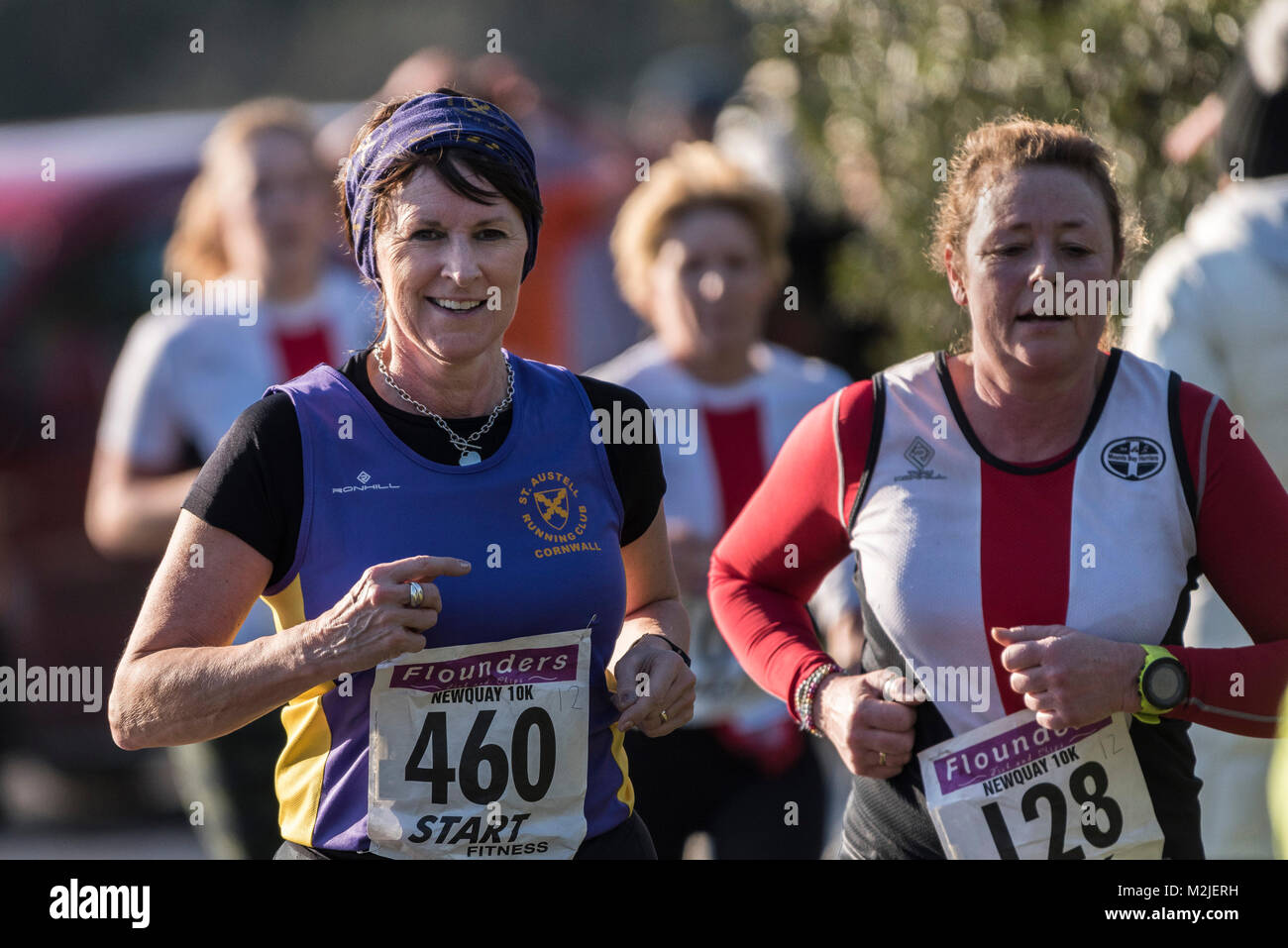 Mature female runners competing in a road race in Newquay Cornwall. Stock Photo