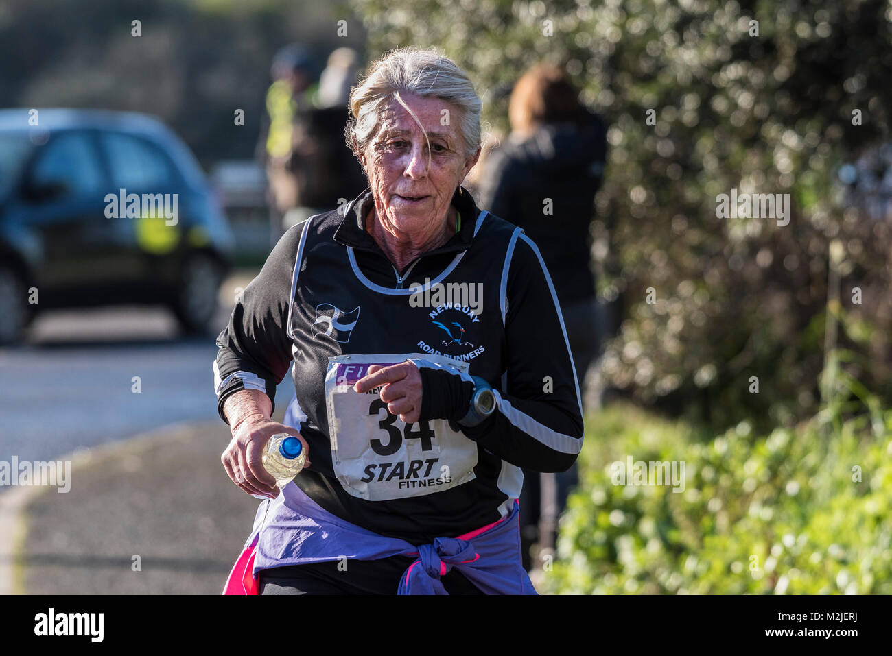 A mature runner competing in a road race in Newquay Cornwall. Stock Photo