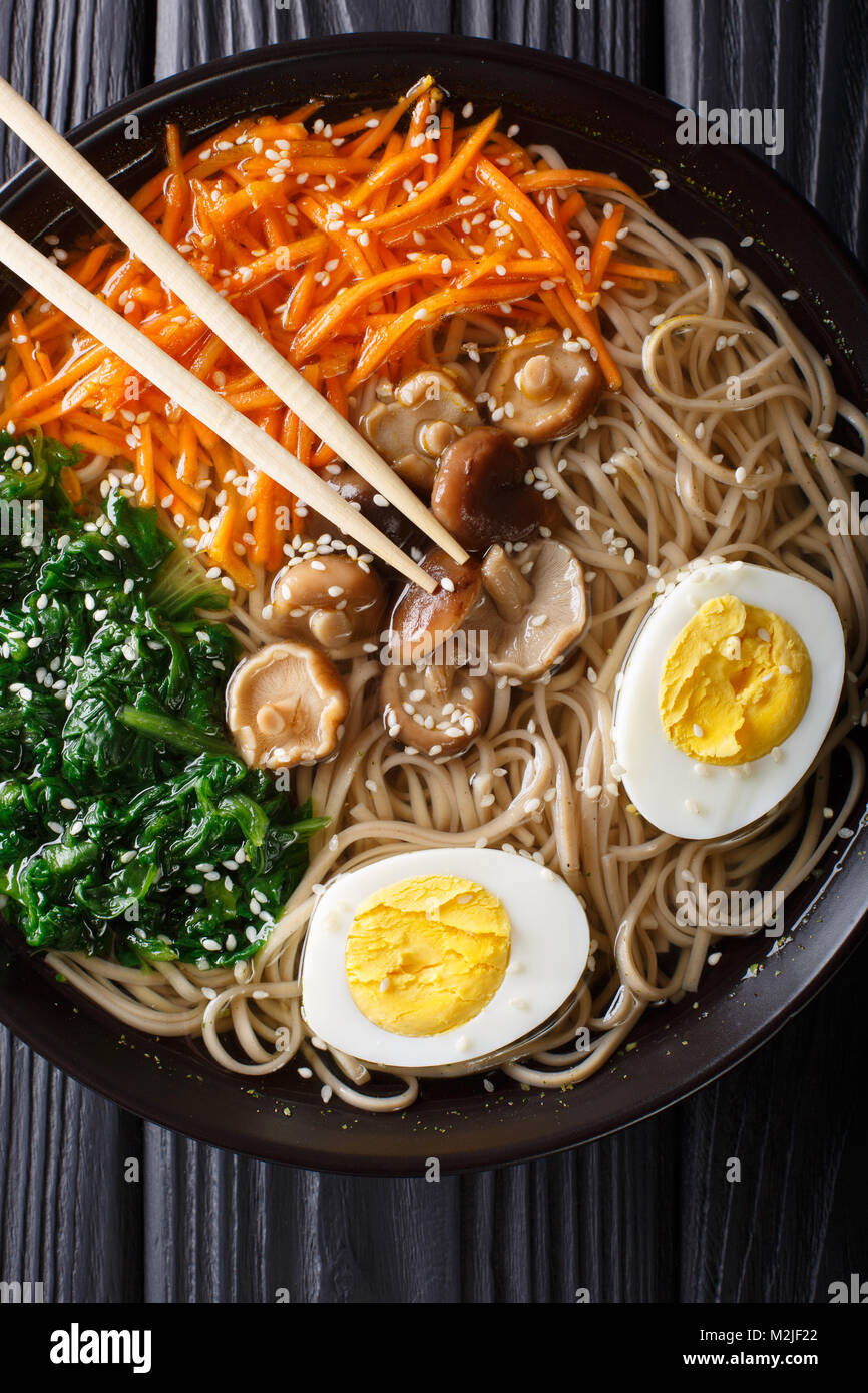 Soba noodles soup with vegetables, shiitake mushrooms, egg and sesame