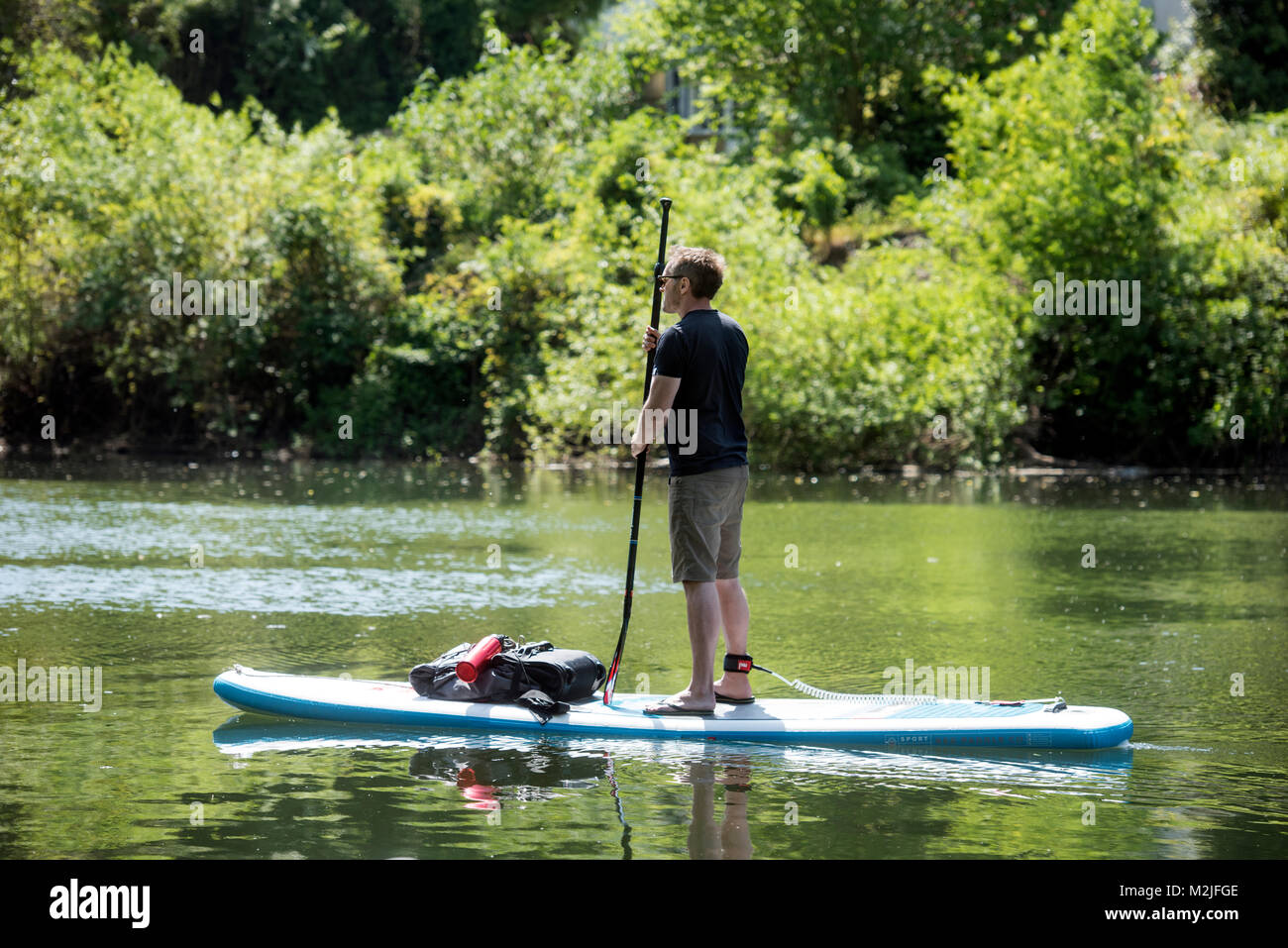 A paddle boarder on the River Wye between Symonds Yat East and West, UK Stock Photo