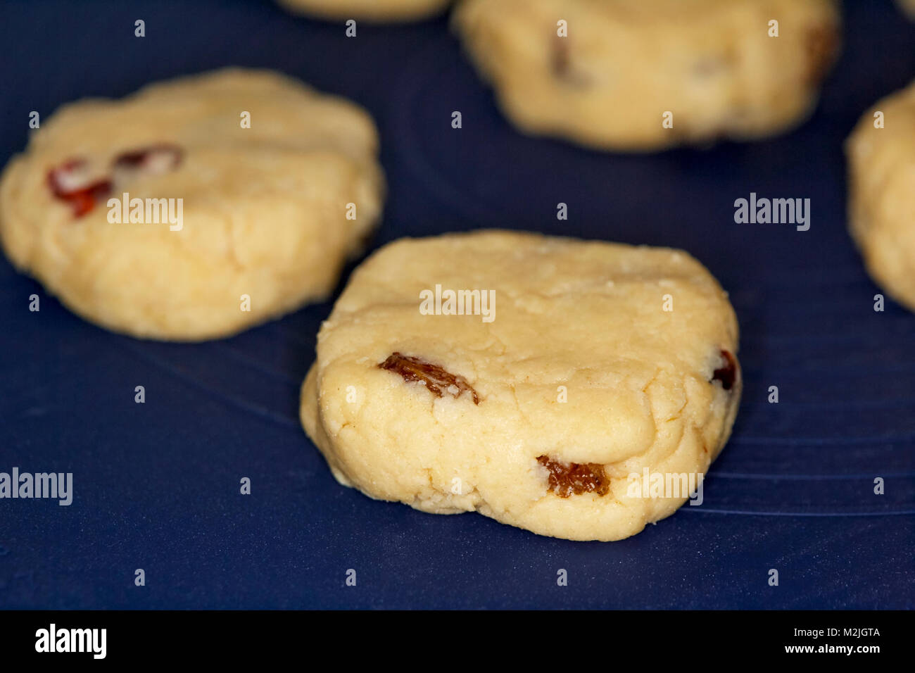 home made fruit scones known as rock cakes on a silicone baking mat ready to go into the oven Stock Photo