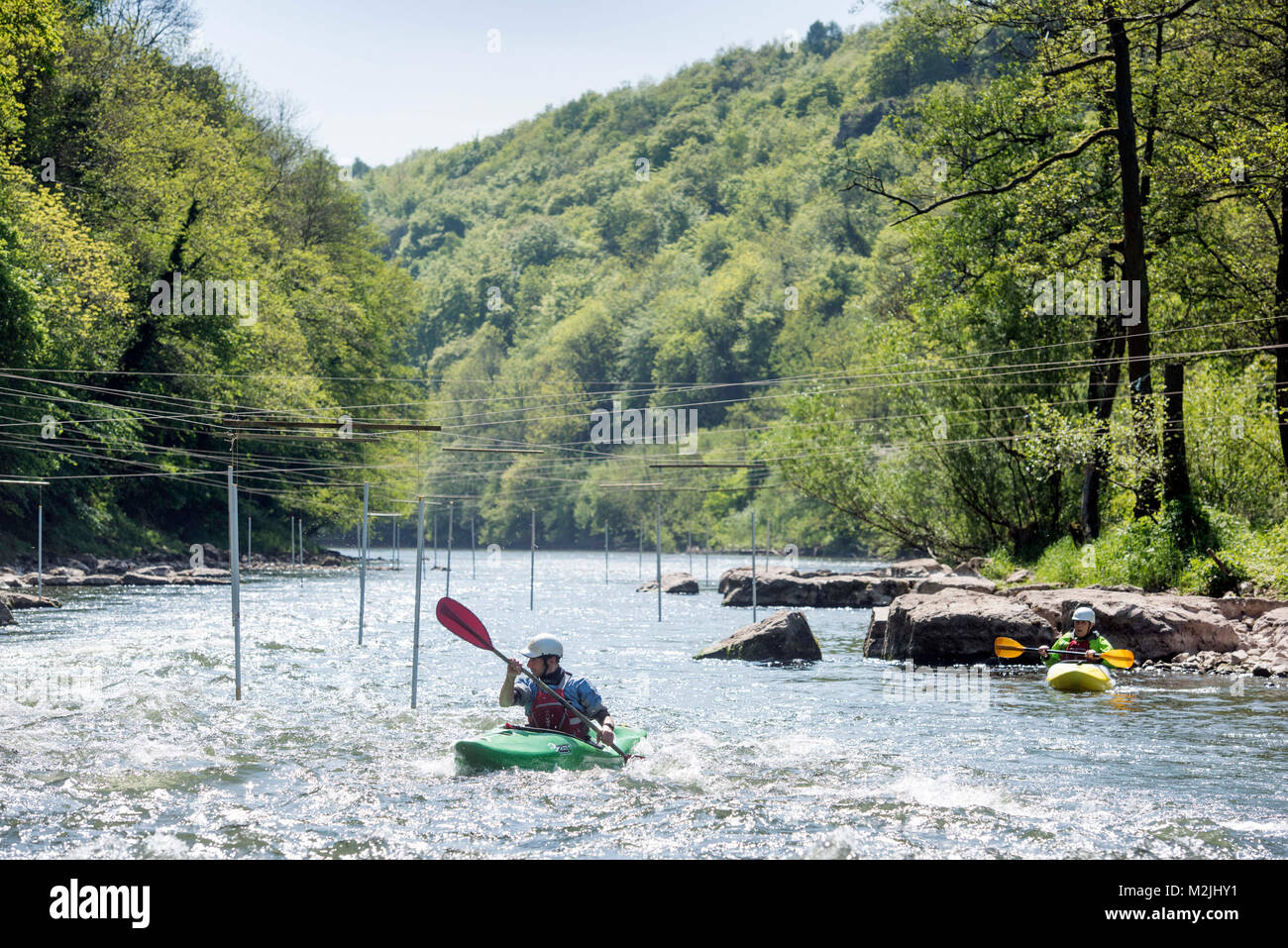 The canoe and kayak coach Ben Matthews (left) leads a pupil across the