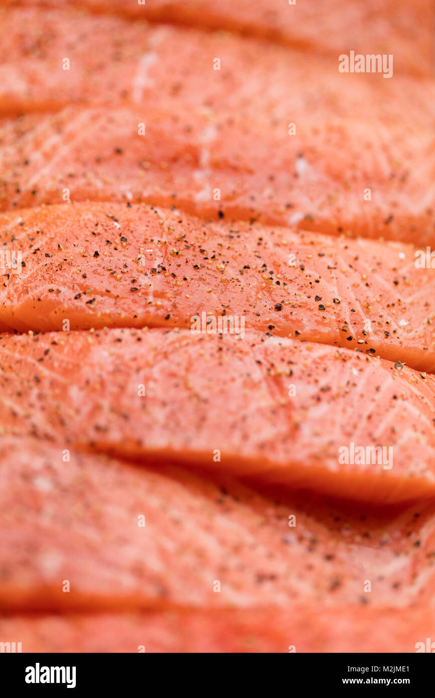 Fresh raw salmon fish fillet background with pepper Stock Photo - Alamy