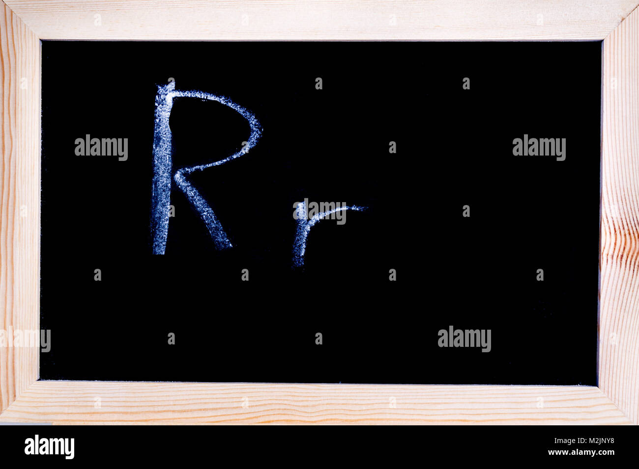 Blackboard with white chalk writing showing capital and lowercase R Stock Photo