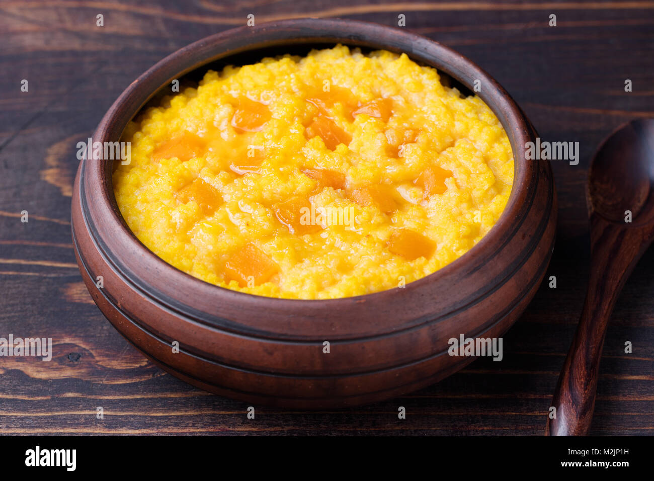 Millet porridge with pumpkin in a clay bowl Stock Photo Alamy