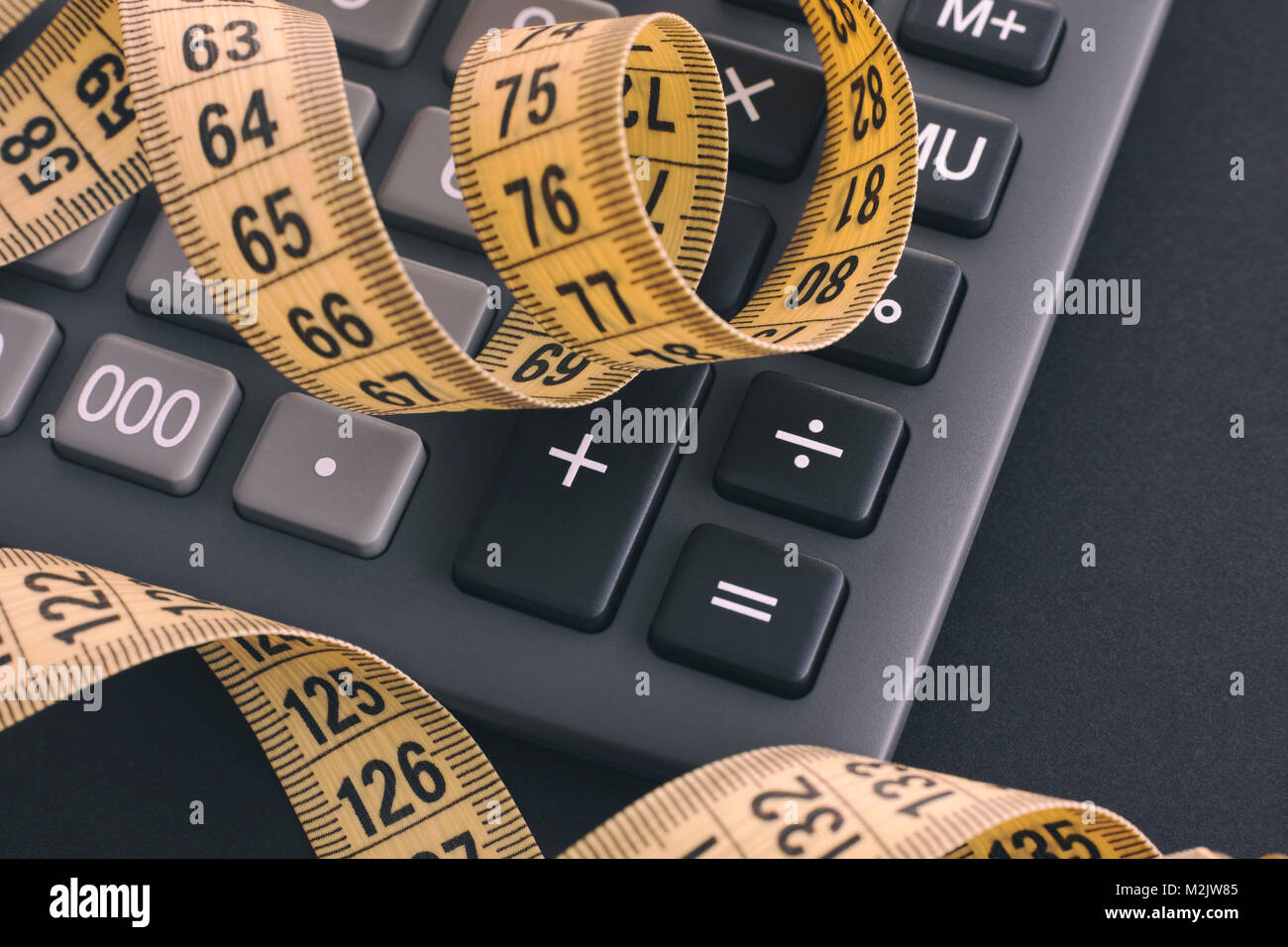 Calculator and yellow tape measure. Close up Stock Photo Alamy