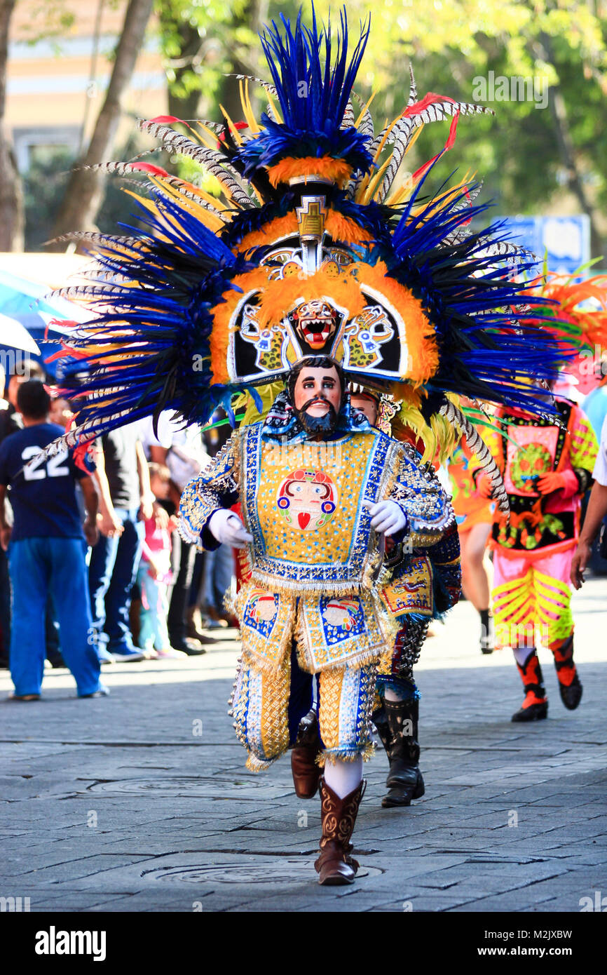 Vertical photo of a Carnival scene, a dancer wearing a traditional mexican folk costume and mask rich in color Stock Photo