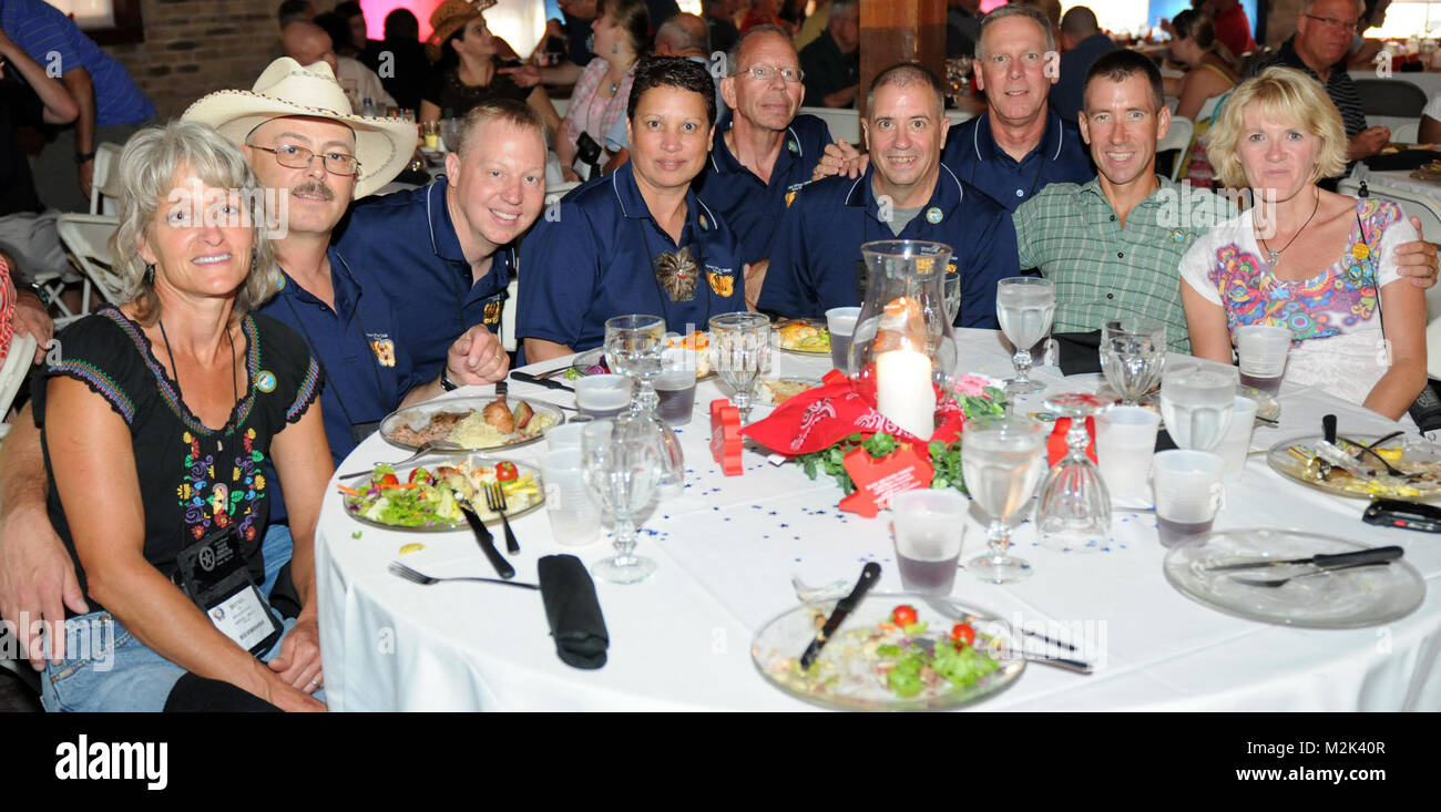 From left to right: Brenda Heitstuman, CW3 Richard Heitstuman, CW5 John Purpuro, CW3 Teresa Purpuro, CW4 Wade A. Van Gilder, CW2 Lance J. Heppner, all of Montana; CW5 Dave Anderson of Nevada, Col. Troy Frost, and CW2 Pam Frost, both from Montana, smile during a warrant officer mixer Aug. 20 at the Copper Tank during the 132nd National Guard Association of the United States General Conference in Austin, Texas. 100820-A-1403C-007 by Texas Military Department Stock Photo