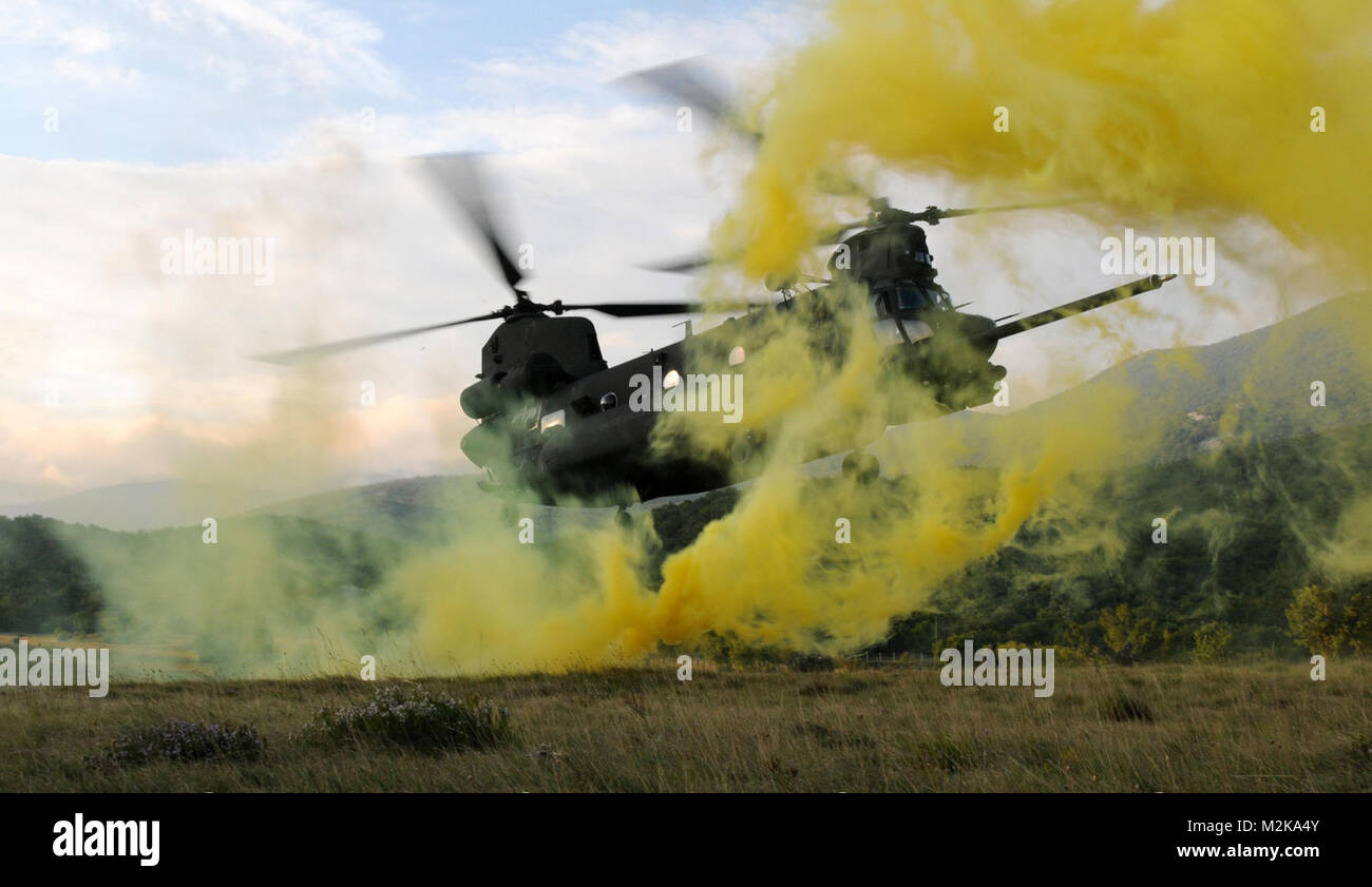 An U.S. Army MH-47 Chinook helicopter, assigned to the 160th Special Operations Aviation Regiment (Airborne), stirs up yellow smoke as it prepares to land on a landing zone in Kovachevo, Croatia as part of the Jackal Stone 2009 exercise held in Croatia. The international special operations exercise, co-organized by the Special Operations Battalion of General Staff of the Croatian Armed Forces and U.S. Special Operations Command Europe, is being conducted to enhance the capabilities and interoperability of the soldiers particiapting. Yellow smoke by EUCOM Stock Photo