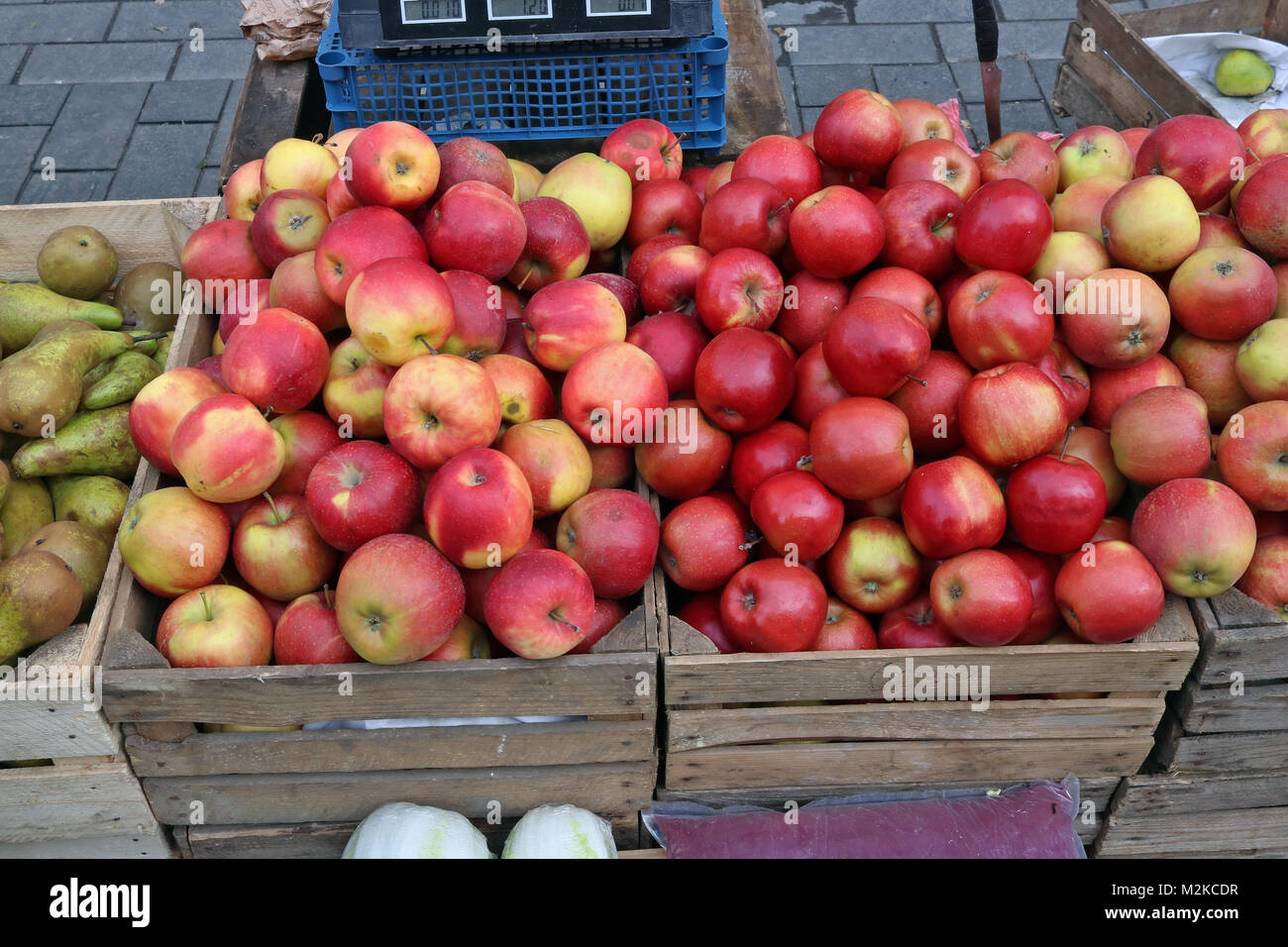 Street market of fresh red garden apples fruits in wooden boxes. Cloudy ...