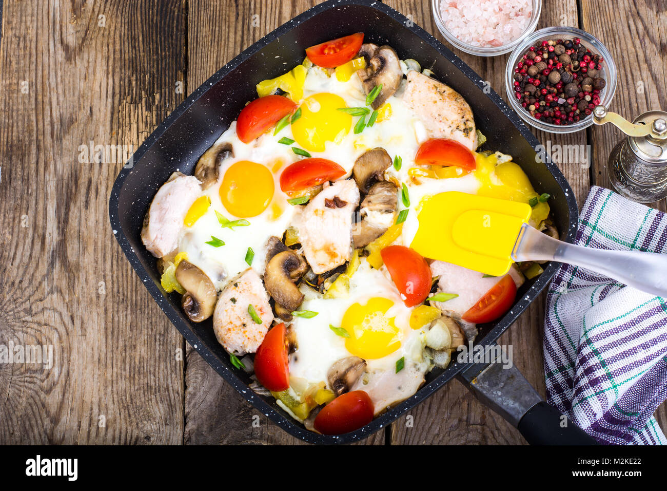 Fried eggs, tomatoes, ham, mushrooms in frying pan Stock Photo Alamy