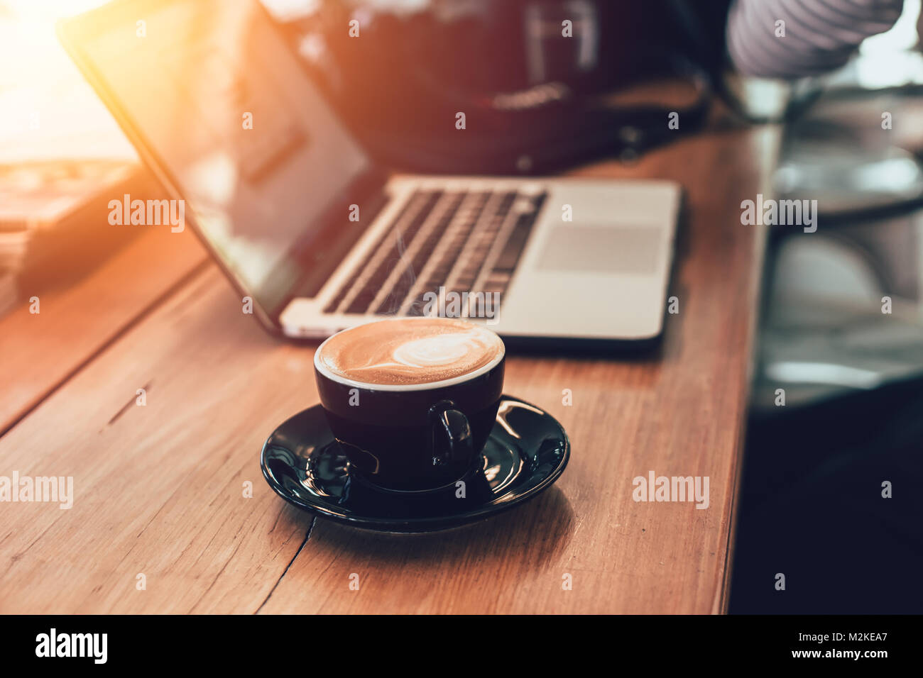 latte coffee with laptop working in cafe concept vintage color tone Stock Photo