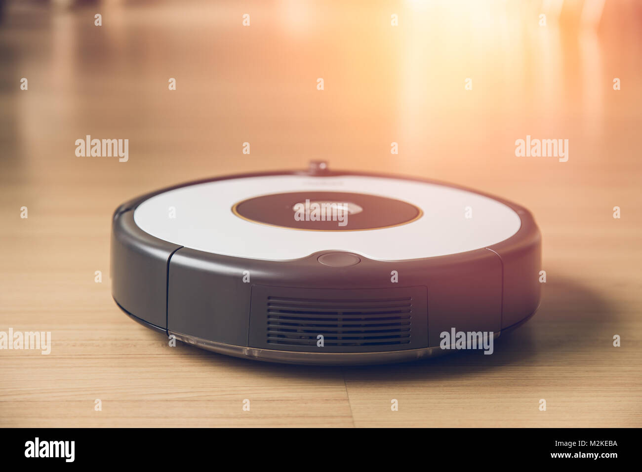 robot vacuum clean wood floor easy home cleaning technology every morning concept Stock Photo