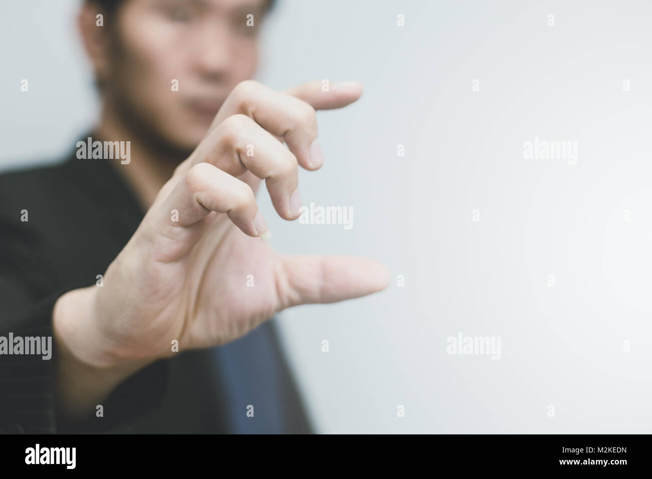 Asian business man with hand finger show size or scale Stock Photo