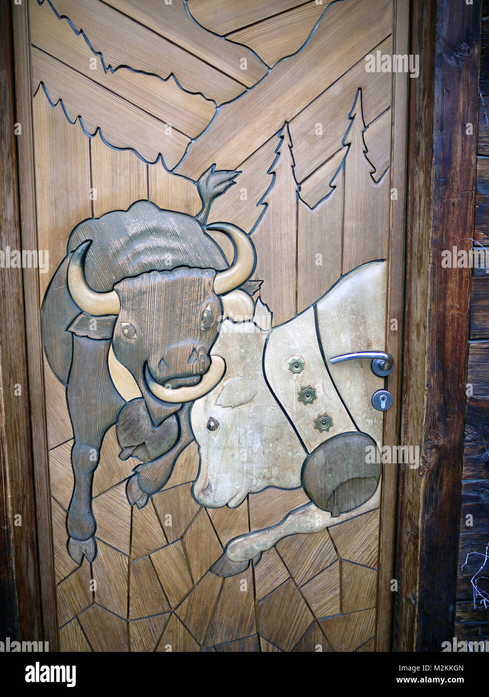 Door to Hotel Moiry in Grimentz detailing the famous fighting cows of the local area, Val d'Herens. The cows fight to see who will be the lead cow. Stock Photo