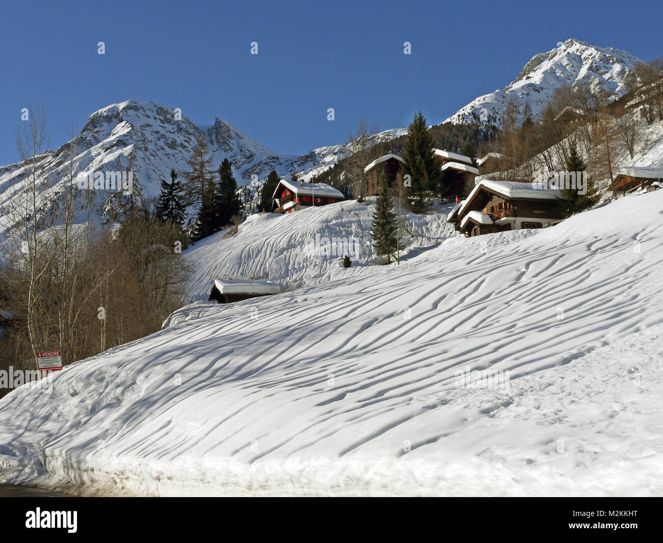 Large amounts of snow fell in January in Grimentz, followed by heavy rain, even up to 2,000 metres causing these rivulates or markings in the snow. Stock Photo
