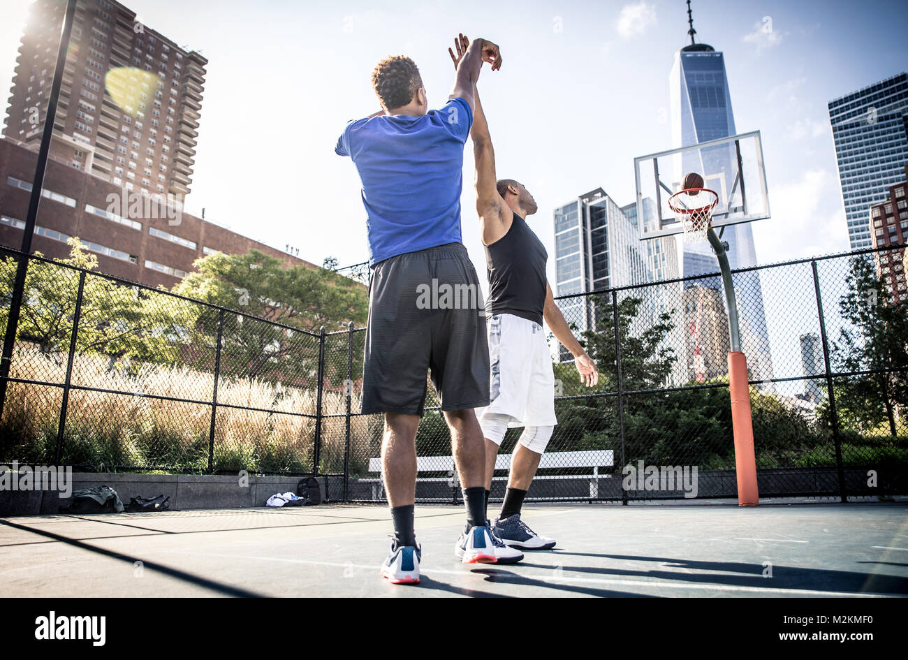 Two street basketball players playing hard on the court Stock Photo Alamy