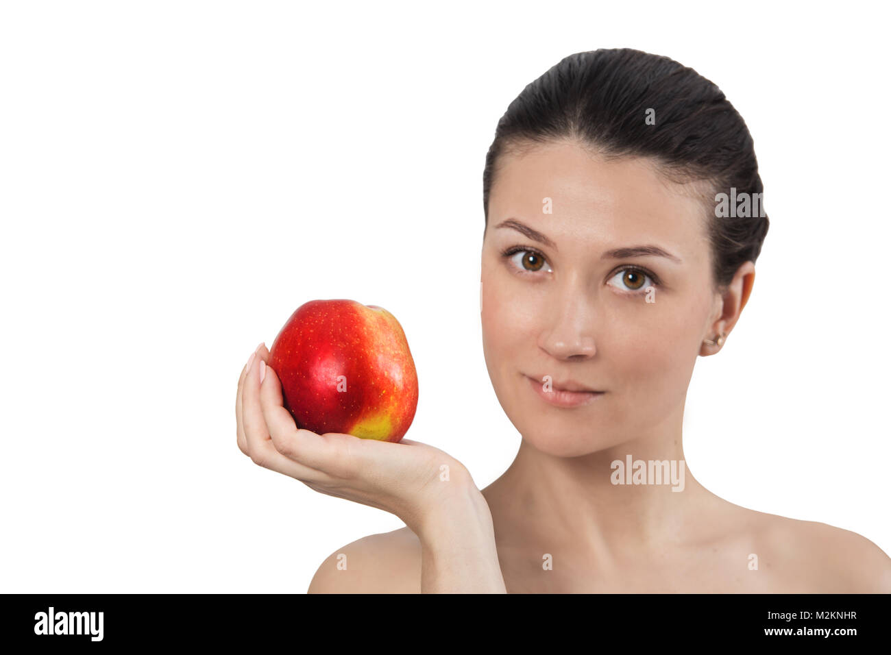 Red apple on hand of model brunette woman isolated on white background. Stock Photo