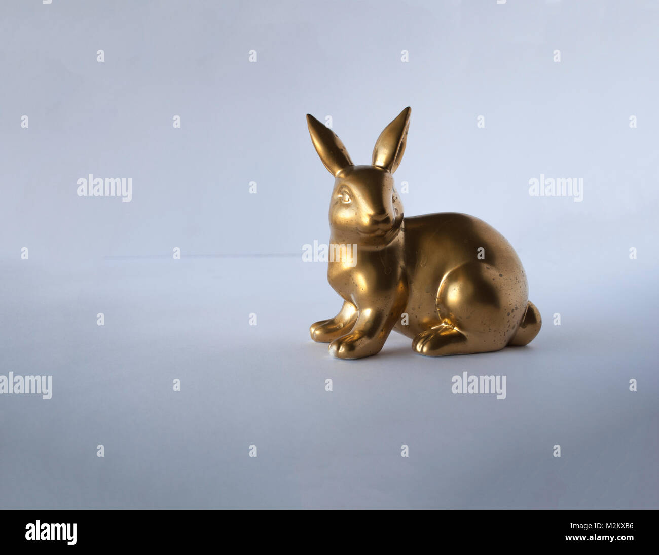Easter golden bunny isolated on green close up Stock Photo