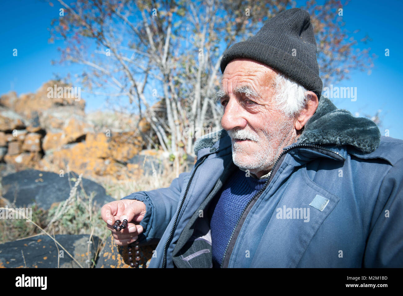 Old shepard nearby the church of Sevanavankat lake Sevan. Stock Photo