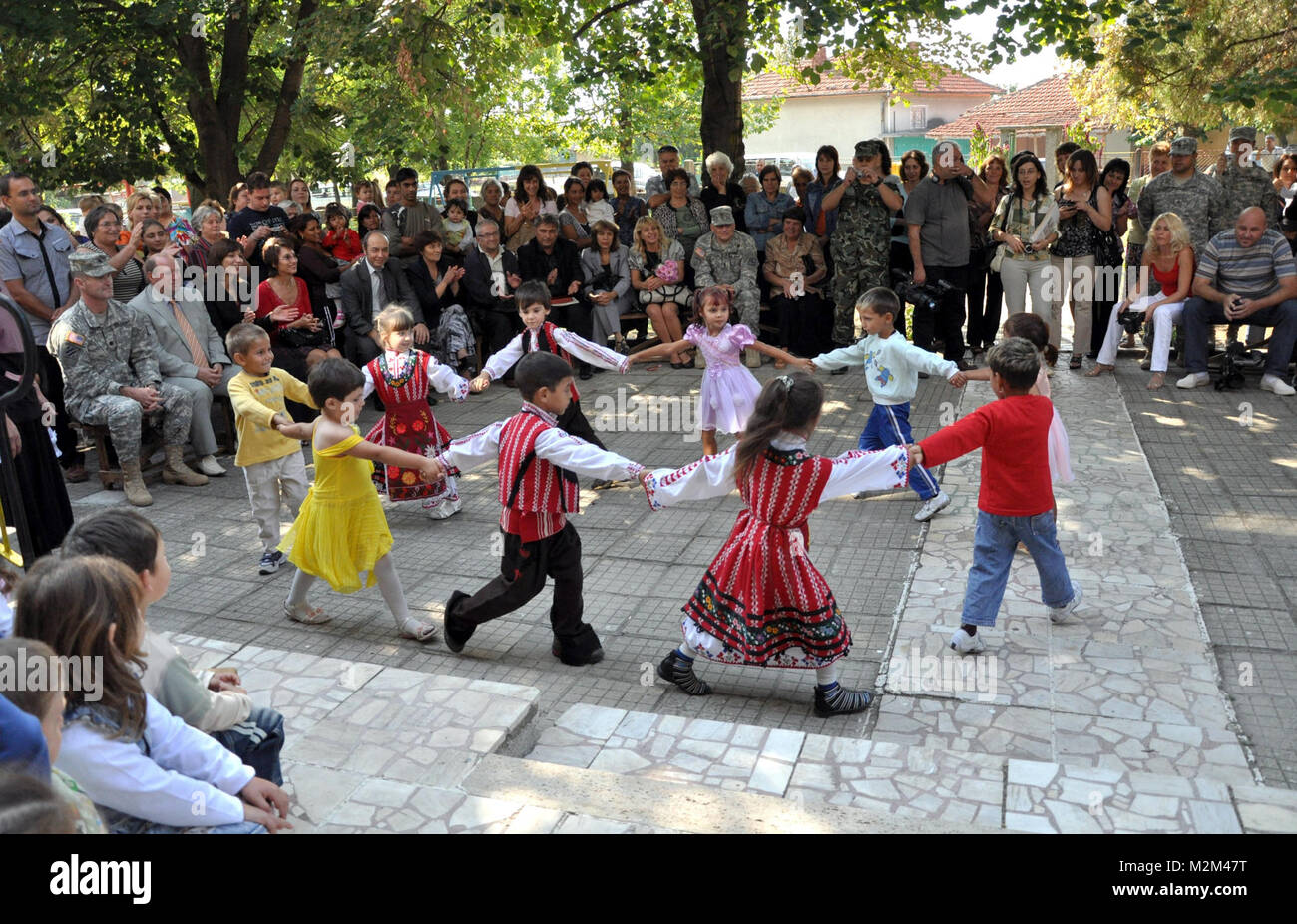 Bulgarian children dance during a ribbon cutting ceremony at the Sinchec Kindergarten by EUCOM Stock Photo