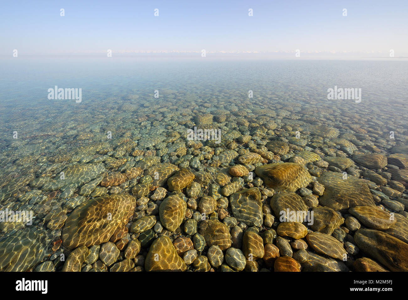 Rest of an old rocks under the clear water. Stock Photo