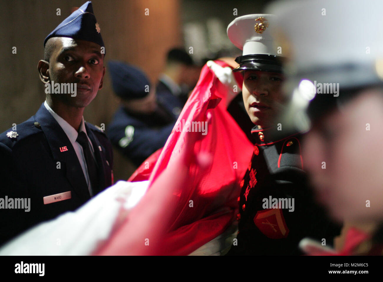 Marines, sailors, airmen, soldiers and West Point cadets wait with an