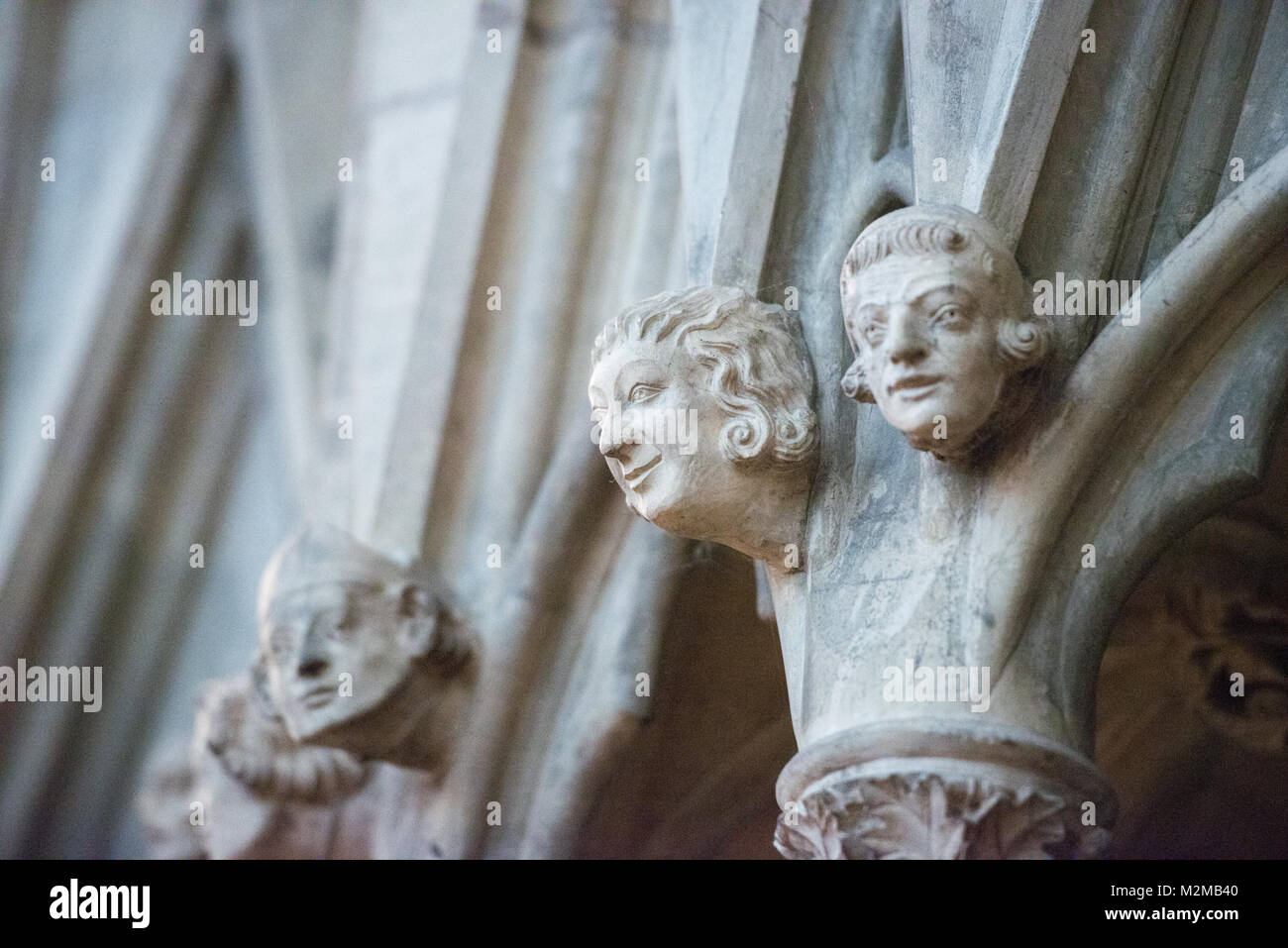 Statues of human faces protruding from the wall of the York Minster