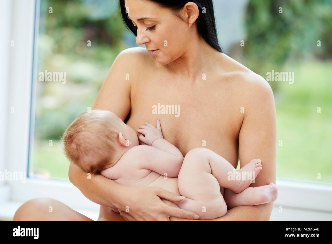 Mother breast feeding her baby Stock Photo - Alamy