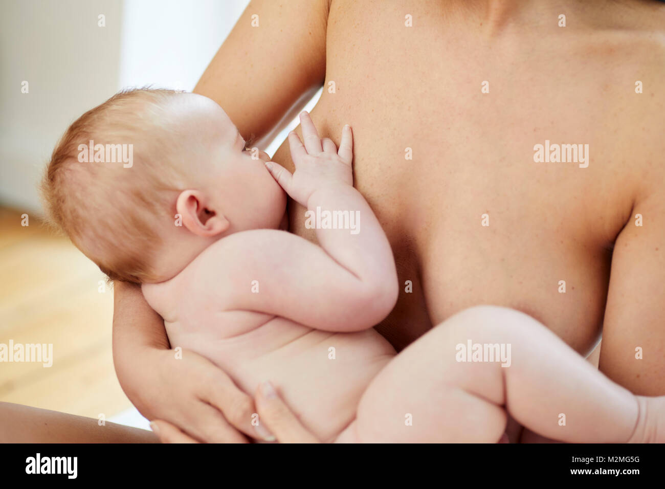 Mother breast feeding her baby Stock Photo - Alamy
