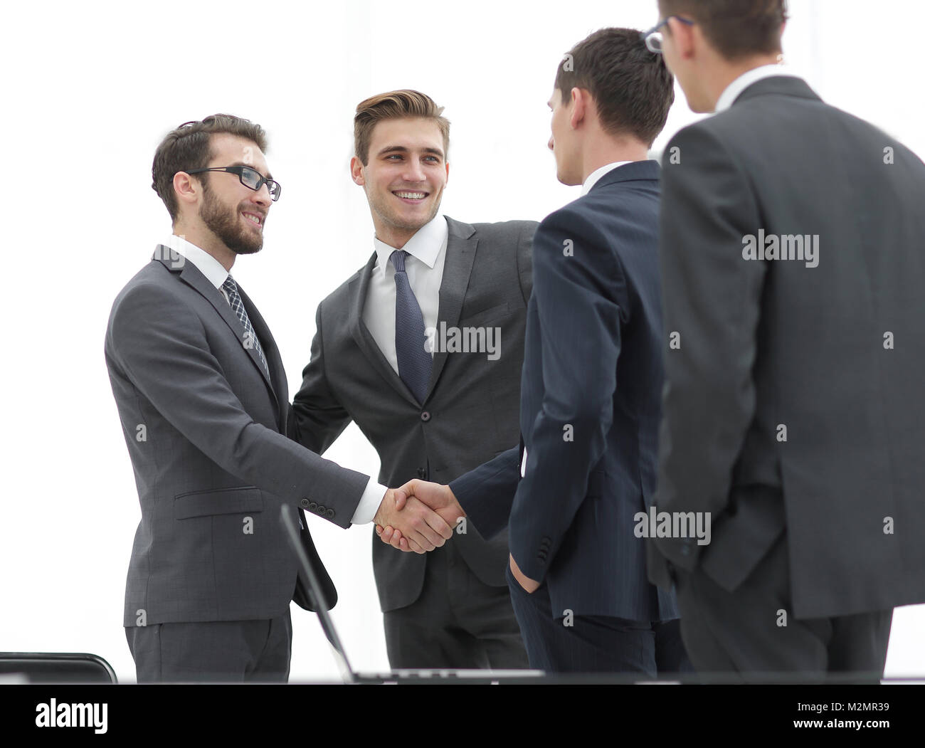 Successful business people shaking hands in an office Stock Photo - Alamy