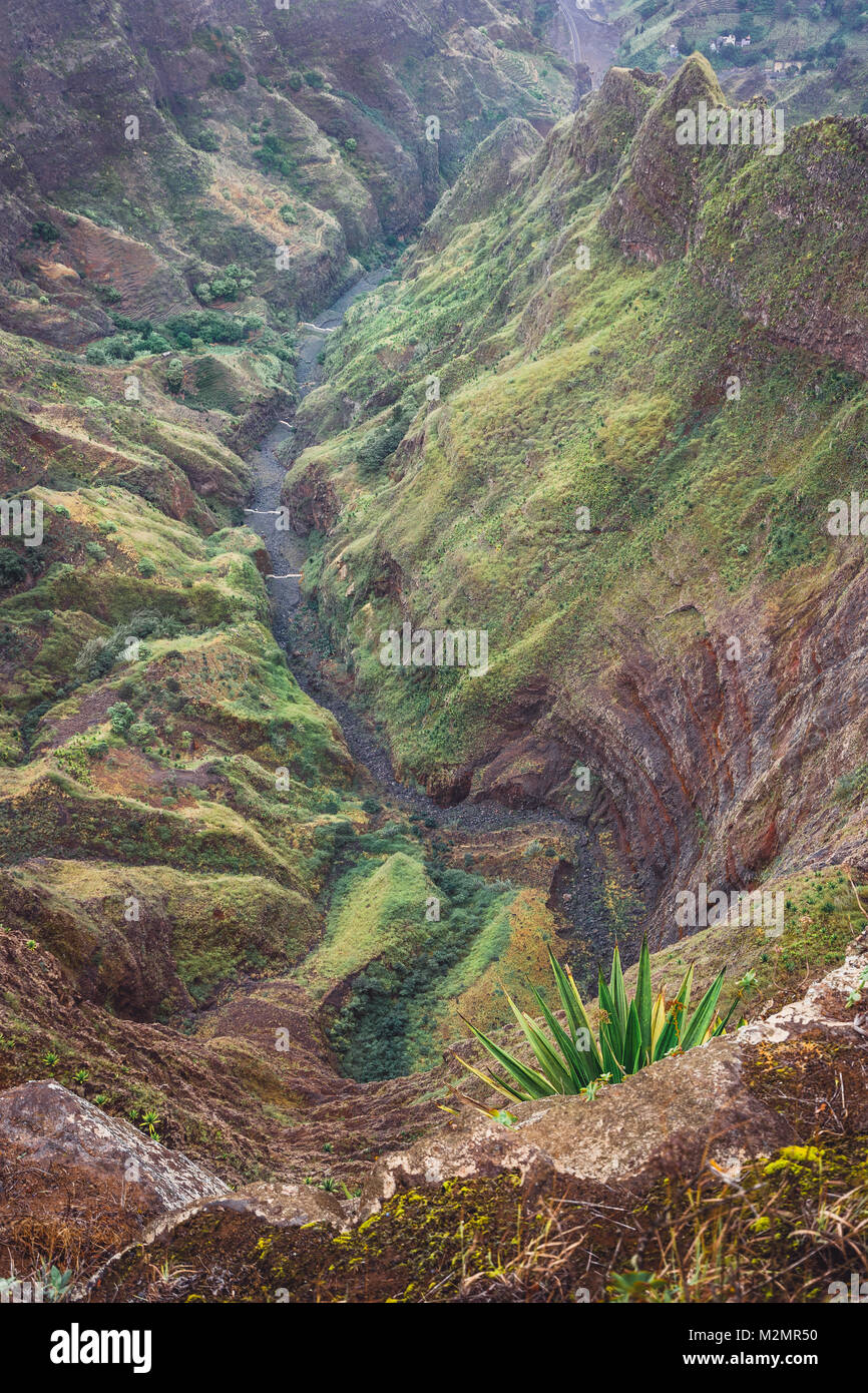 Breathtaking panorama of a steep gorge with winding riverbed and lush green vegetation on Delgadinho mountain ridge. Santo Antao, Cape Verde Stock Photo