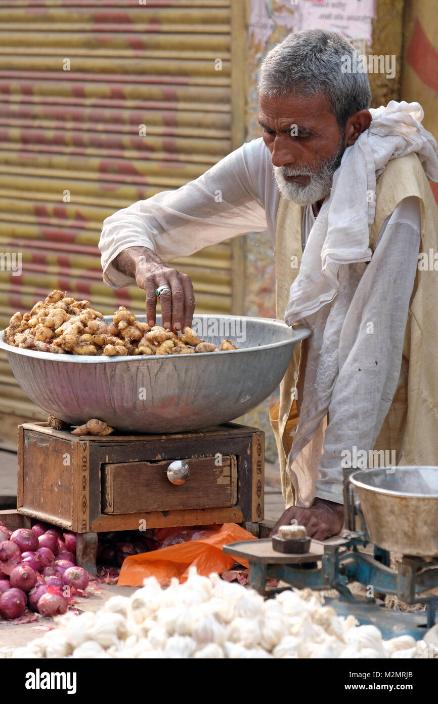 Indian street trader selling ginger , garlic and onions Stock Photo