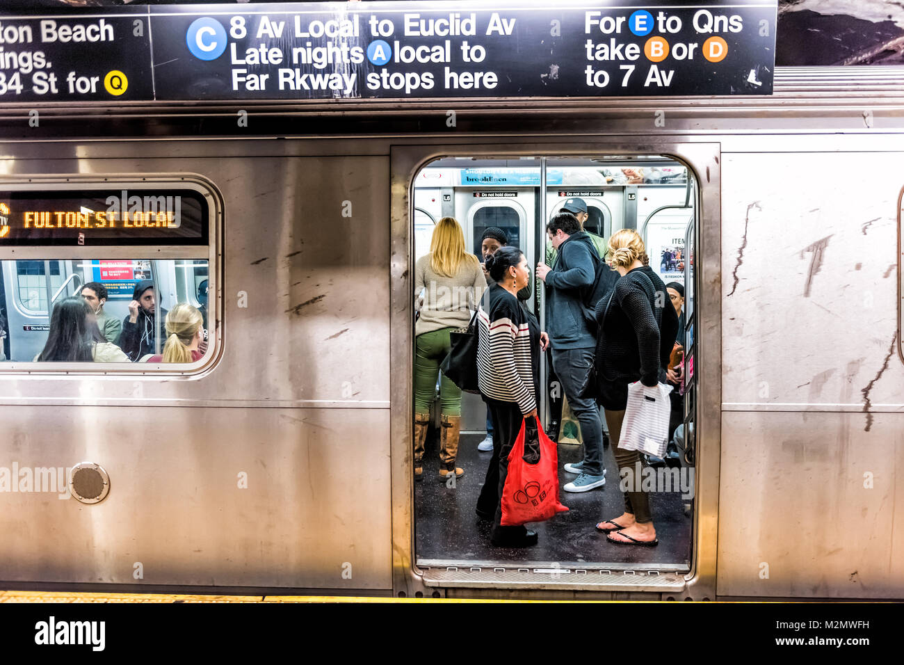 New York City, USA - October 28, 2017: People in underground platform transit in NYC Subway Station on commute with train, people crammed crowd with o Stock Photo