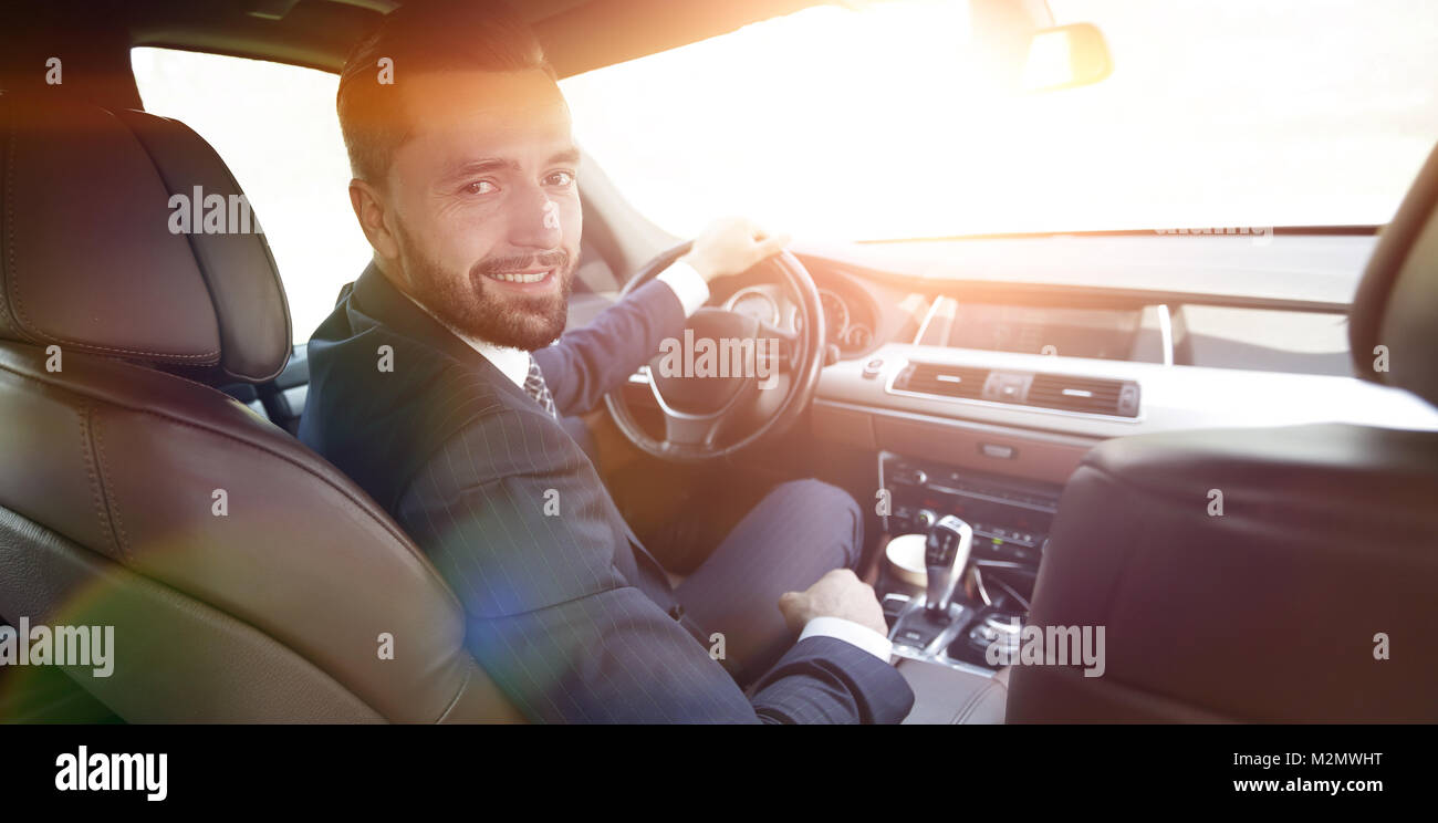 Successful man sitting behind the wheel of a car Stock Photo - Alamy
